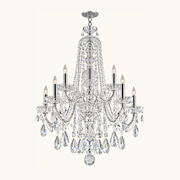 A multi-light crystal chandelier with a polished silver-tone metal frame, featuring clear hanging teardrop crystals and candle-style bulbs, shown against a solid off-white background.