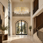Chatter 12-light pendant in gold mirror displayed in a limestone European contemporary foyer