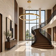 Corona 4 LED ring pendant in bright satin aluminum displayed in a limestone architectural-modern foyer