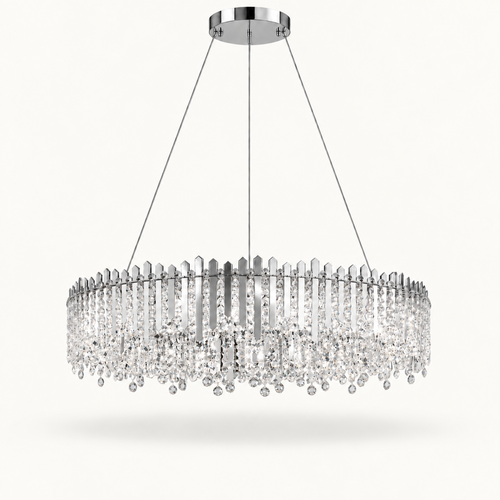 A modern circular chandelier with a polished silver-tone metal frame and numerous clear crystal prisms and hanging drops, suspended by thin cables from a round ceiling canopy against a light off-white background.
