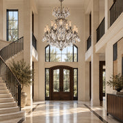 Renaissance Rock Crystal 15-light chandelier in antique pewter displayed in a walnut and limestone estate foyer