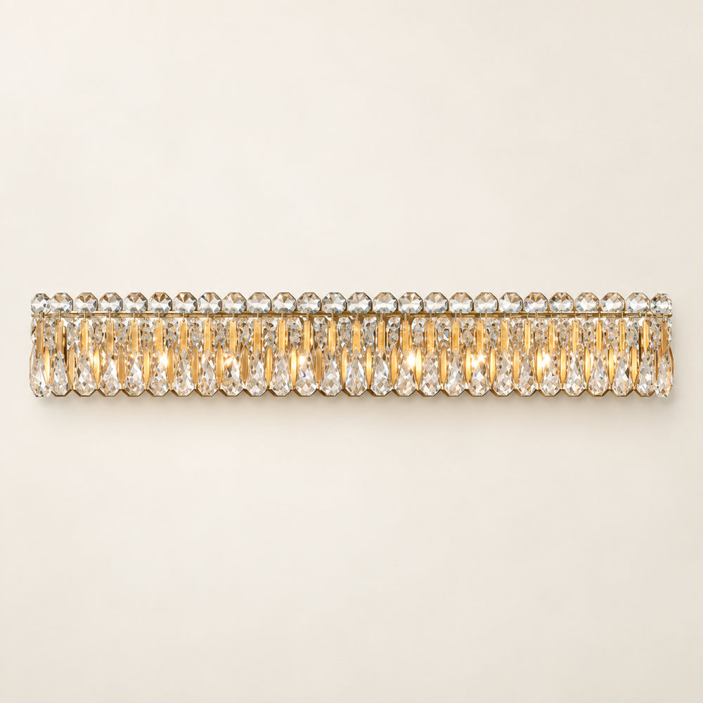 Sarella 8-light wall sconce in heirloom gold with heritage crystal on a warm ivory background