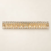 Sarella 8-light wall sconce in heirloom gold with heritage crystal on a warm ivory background