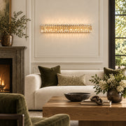 Sarella 8-light wall sconce in heirloom gold with heritage crystal displayed in an olive-accented contemporary estate living room